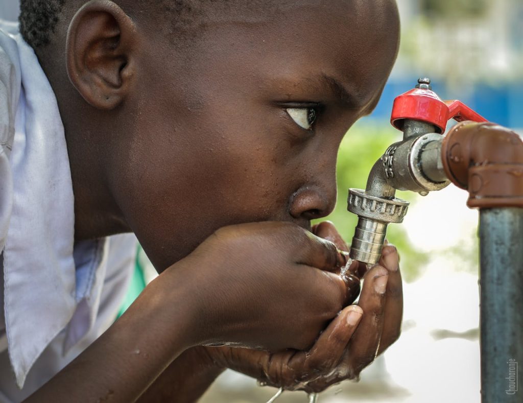 Boy Drinking Water on Faucet